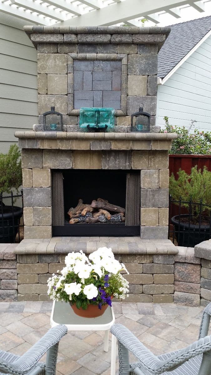 picture of a paver fireplace with beautiful paver retaining wall and textured pavers in stockton california